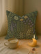 A rectangular 17x18-inch decorative throw pillow featuring a botanical woven tapestry design with embroidered flowers and leaves in green, yellow, and purple tones on a dark green background. The pillow has a double-sided print and is filled with plush poly fill, sewn closed for a soft and cozy finish. Ideal for whimsigoth decor, garden-inspired living spaces, or as a thoughtful embroidered home gift.